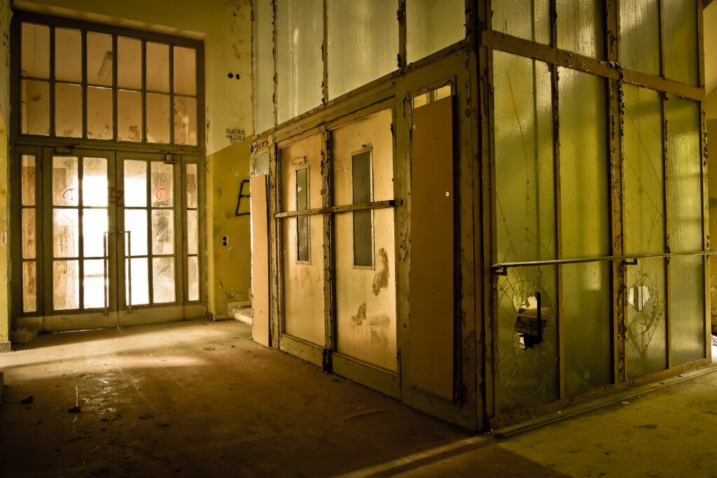 Understanding Elevator Code Compliance: What You Need to Know old broken elevator in a warehouse building