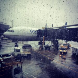 airplane outside while raining at gate Airport Elevator Remote Monitoring
